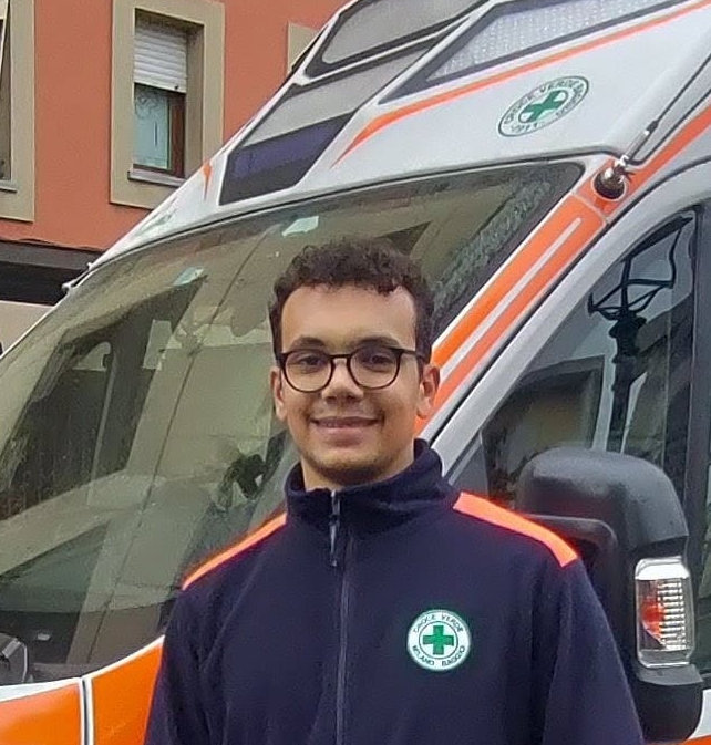 Samuele Gonnella in EMT uniform with an ambulance in the background